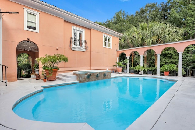 view of pool featuring an in ground hot tub and a patio