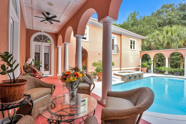 view of swimming pool with french doors, a patio, ceiling fan, and an in ground hot tub