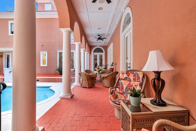 hall featuring decorative columns and crown molding