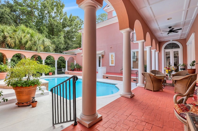 view of pool featuring a patio area, ceiling fan, and french doors