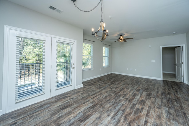 interior space with ceiling fan with notable chandelier and dark hardwood / wood-style floors