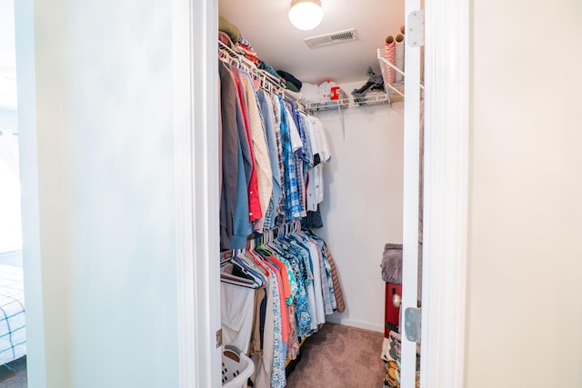 walk in closet featuring carpet flooring