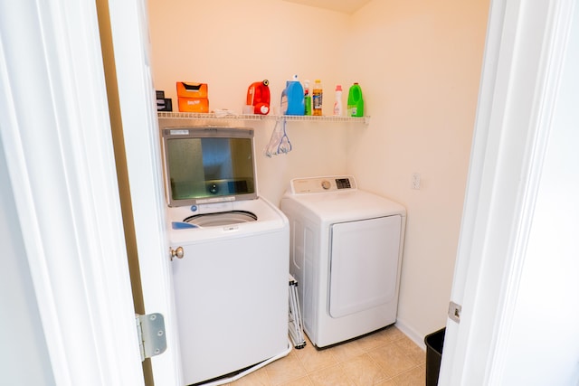 laundry area featuring independent washer and dryer and light tile patterned flooring