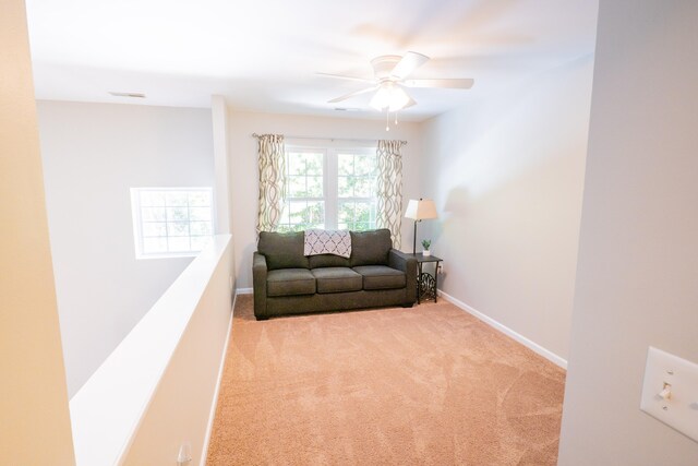 living room featuring light carpet and ceiling fan