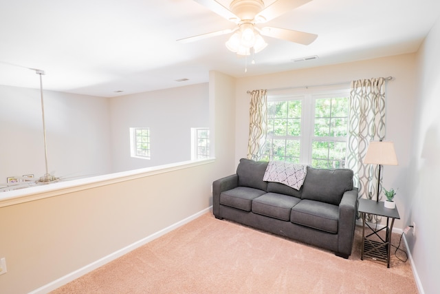 living room with light carpet and ceiling fan