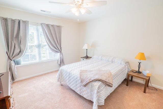 bedroom featuring light carpet and ceiling fan