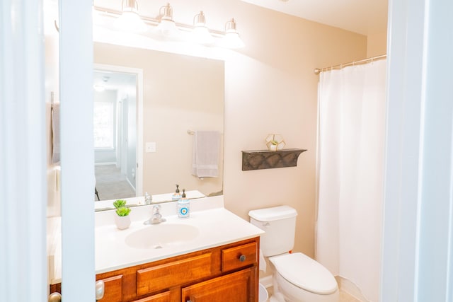 bathroom featuring toilet and vanity