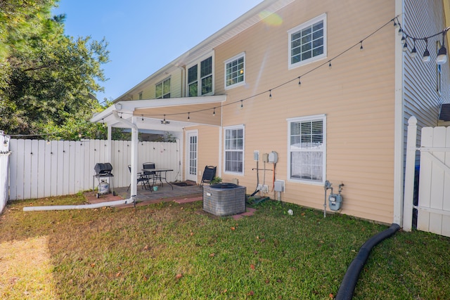 back of property featuring a yard, a patio area, and central AC unit