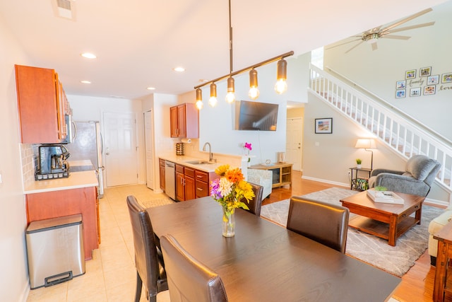 tiled dining area with sink and ceiling fan