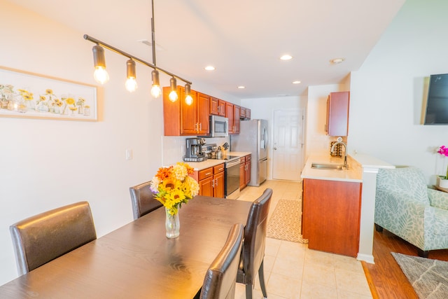 dining area featuring sink and light wood-type flooring