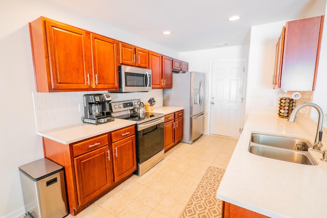 kitchen featuring stainless steel appliances, tasteful backsplash, sink, and light tile patterned flooring