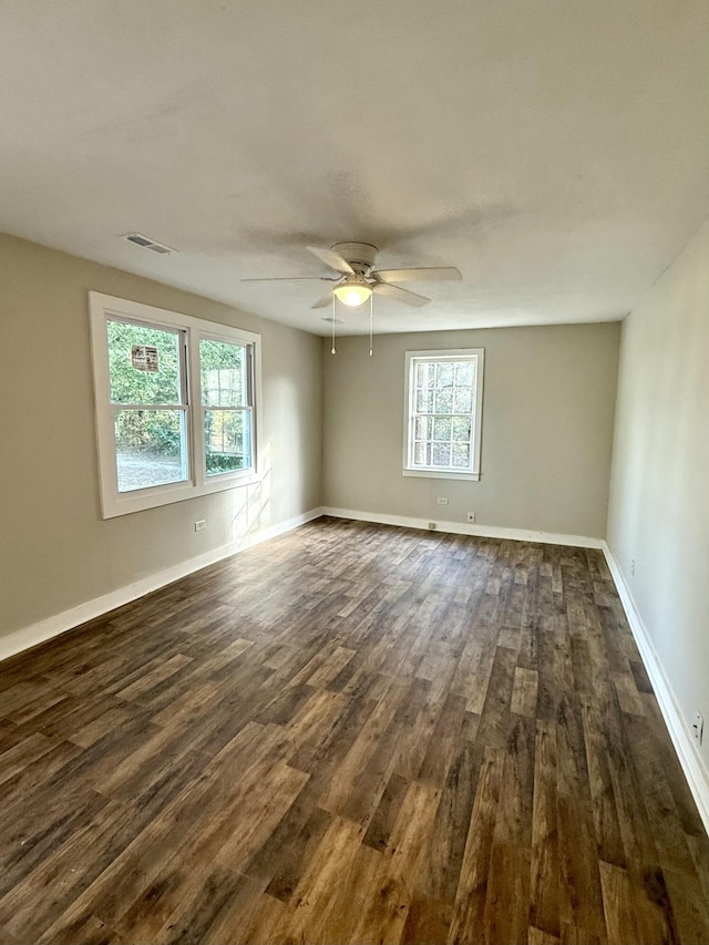 empty room featuring dark hardwood / wood-style floors and ceiling fan