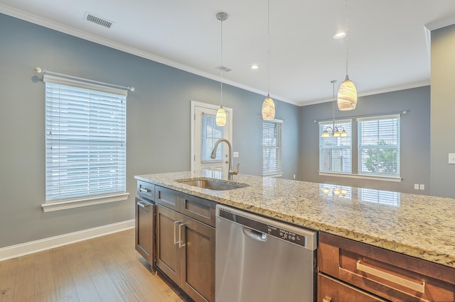 kitchen featuring sink, light stone countertops, light wood-type flooring, stainless steel dishwasher, and pendant lighting