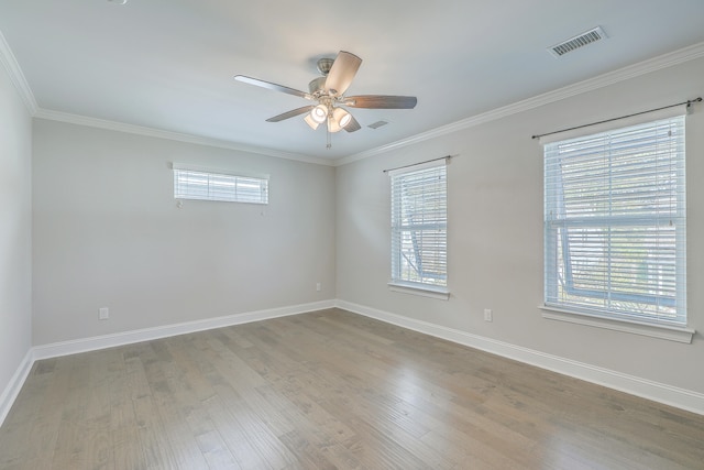 unfurnished room featuring ceiling fan, wood-type flooring, and crown molding