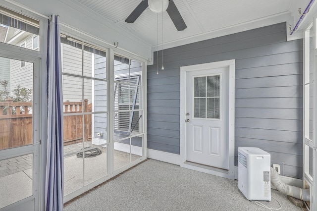 unfurnished sunroom featuring ceiling fan