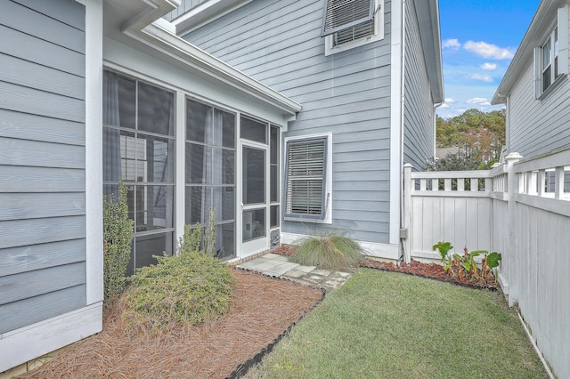 view of exterior entry featuring a yard