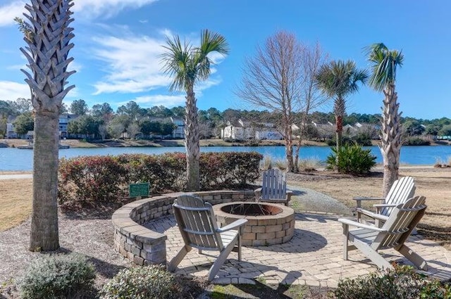 view of patio / terrace featuring a water view and an outdoor fire pit