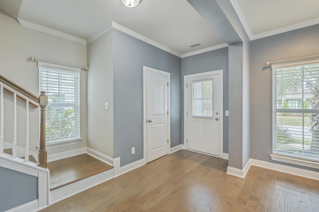 entrance foyer featuring light hardwood / wood-style floors and crown molding