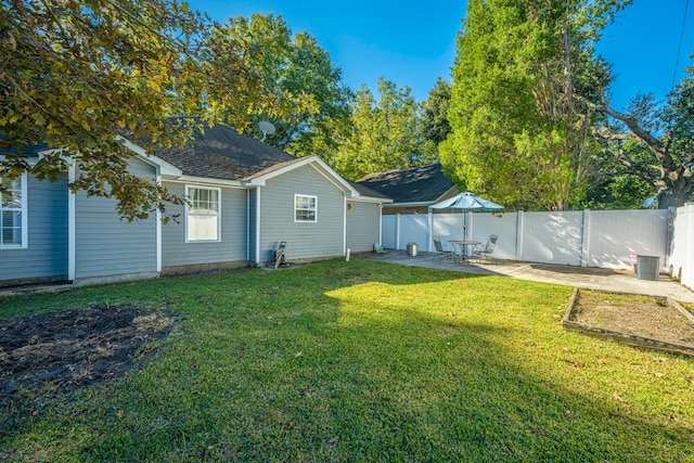 back of property with a yard and a patio area