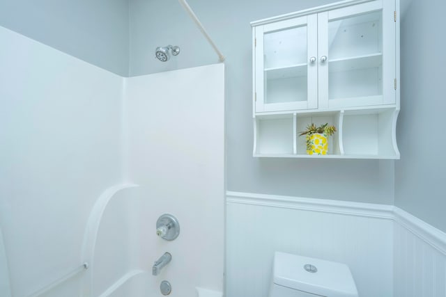 bathroom with toilet and shower / washtub combination