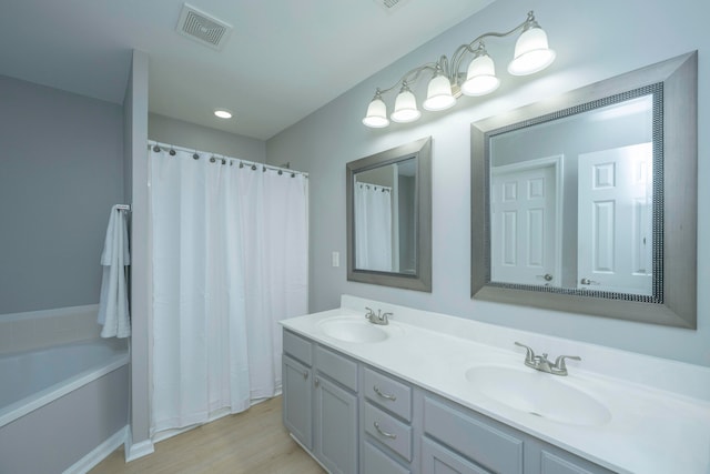 bathroom featuring vanity, hardwood / wood-style floors, and separate shower and tub