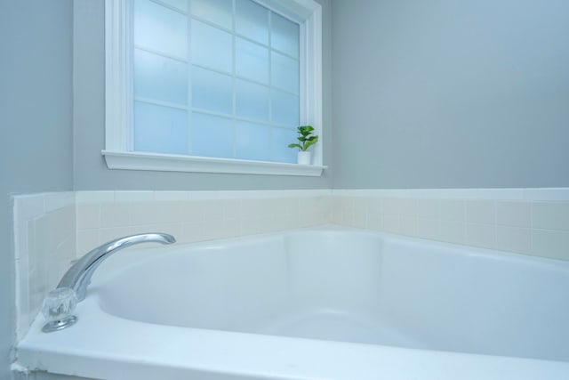 bathroom with a tub to relax in