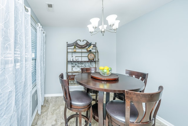 dining space with a notable chandelier