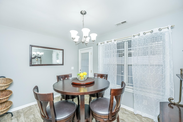 dining area featuring a notable chandelier