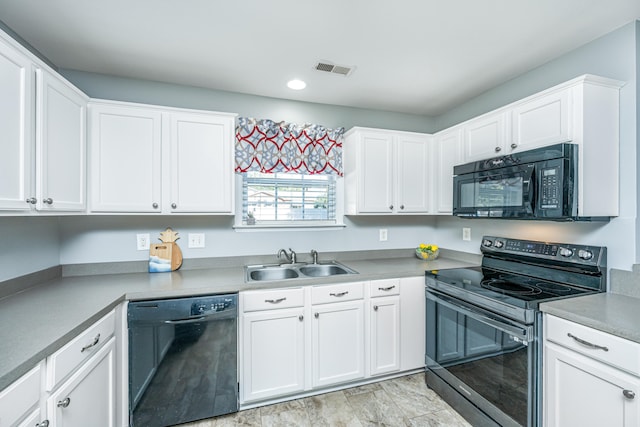 kitchen featuring white cabinetry, black appliances, and sink