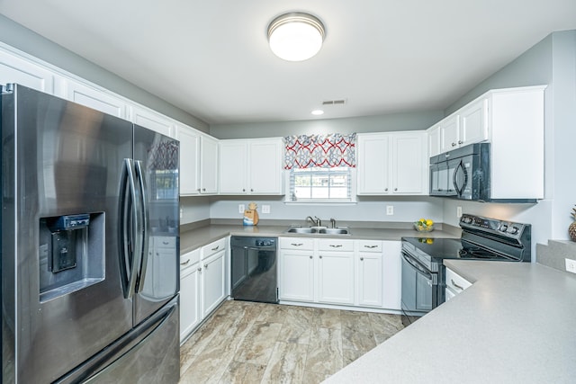 kitchen with white cabinetry, black appliances, and sink