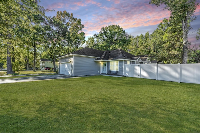 view of front of property featuring a yard and a garage