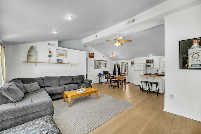 living room with visible vents, lofted ceiling, a ceiling fan, and light wood finished floors