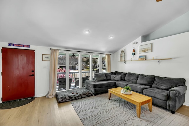 living area featuring recessed lighting, light wood-type flooring, visible vents, and vaulted ceiling