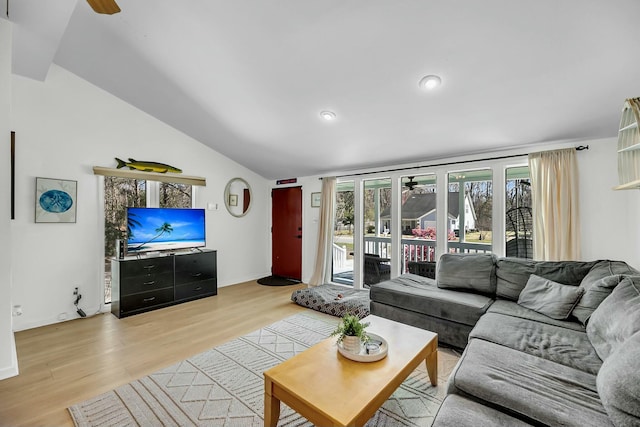 living area featuring light wood-style flooring, ceiling fan, and vaulted ceiling