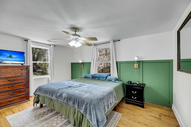 bedroom with light wood-style flooring and ceiling fan