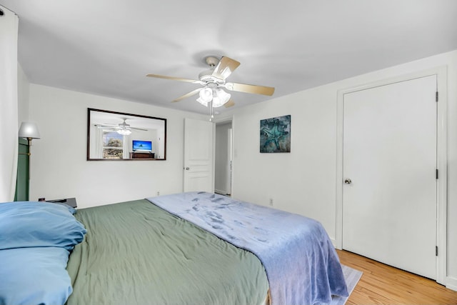 bedroom with light wood-type flooring and a ceiling fan