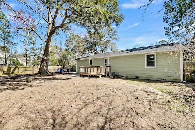 back of house featuring crawl space, cooling unit, a deck, and fence