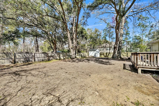 view of yard featuring a deck and fence