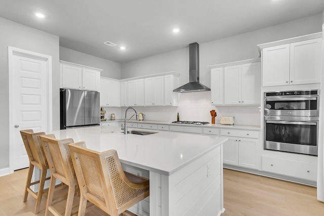 1017 Marsh Royal St, Summerville, SC 29485 - kitchen featuring wall chimney exhaust hood, stainless steel appliances, a sink, white cabinets, and recessed lighting
