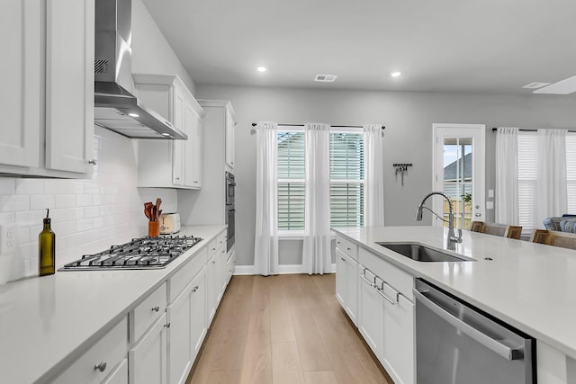 1017 Marsh Royal St, Summerville, SC 29485 - kitchen with wall chimney exhaust hood, stainless steel appliances, a sink, light countertops, and recessed lighting