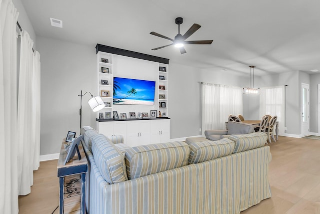 1017 Marsh Royal St, Summerville, SC 29485 - living room featuring baseboards, ceiling fan, and light wood-style floors