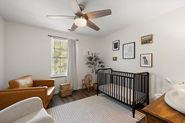 312 Kelsey Blvd, Wando, SC 29492 - bedroom featuring wood finished floors, a crib, and ceiling fan