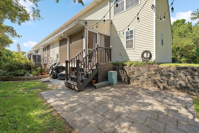 312 Kelsey Blvd, Wando, SC 29492 - rear view of property with a patio, a sunroom, and a lawn