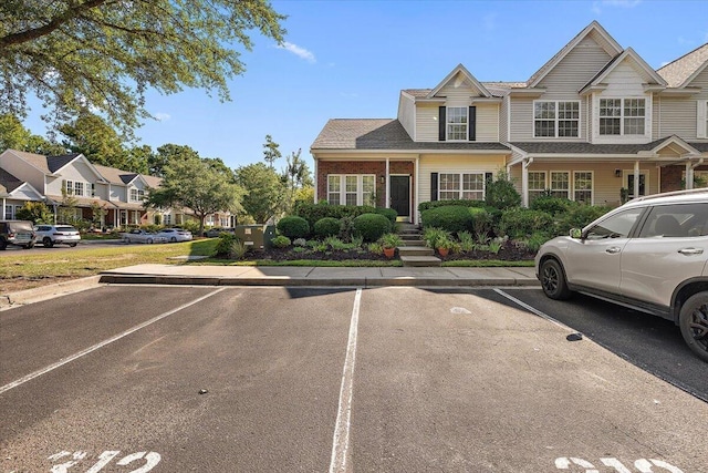 312 Kelsey Blvd, Wando, SC 29492 - view of front facade with uncovered parking, a residential view, and brick siding