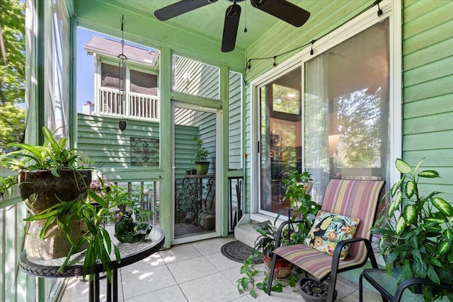 sunroom with a wealth of natural light and a ceiling fan