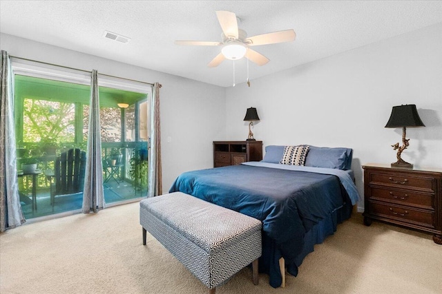 bedroom with a ceiling fan, access to exterior, visible vents, and carpet