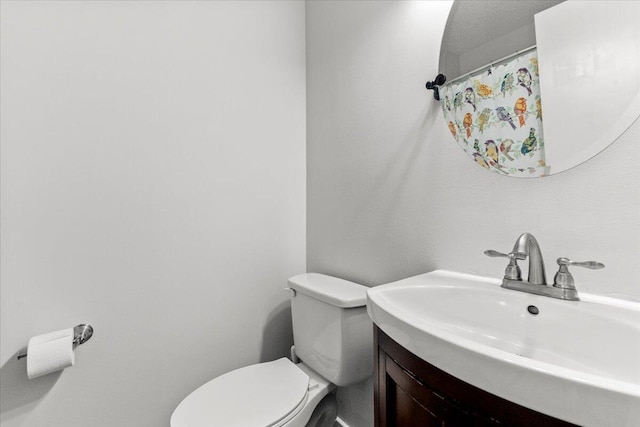 bathroom with toilet and vanity