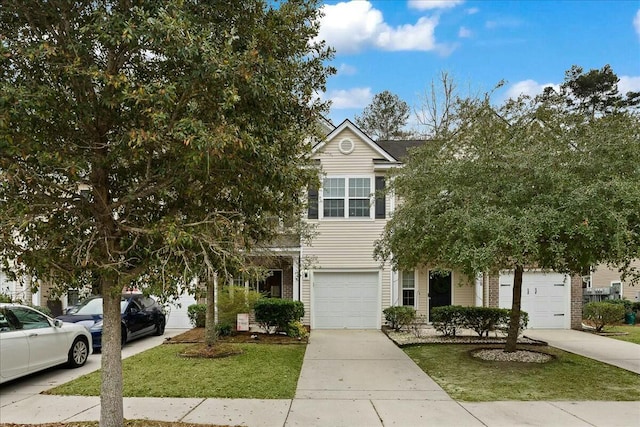 view of property hidden behind natural elements featuring a garage and a front yard