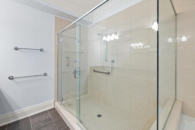 bathroom with tile patterned flooring, a shower with door, and ornamental molding