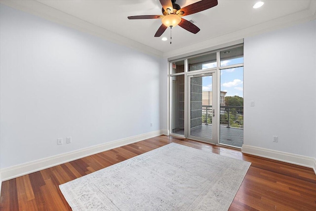 spare room featuring ceiling fan, ornamental molding, and dark wood-type flooring